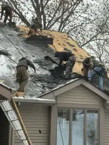 storm damaged roof with missing shingles after severe weather